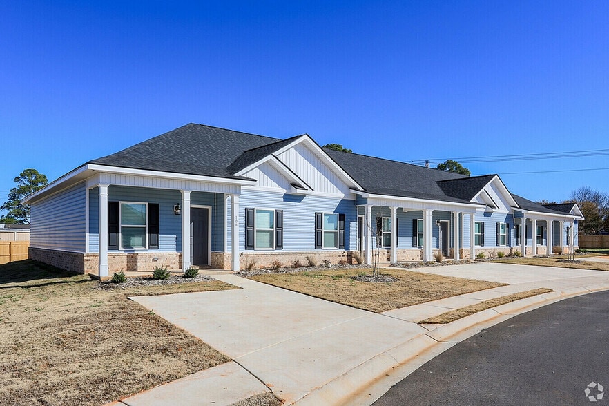 Welcome to your new home in these charming blue villas, where modern comfort meets classic style. - Woodford Ridge Townhomes