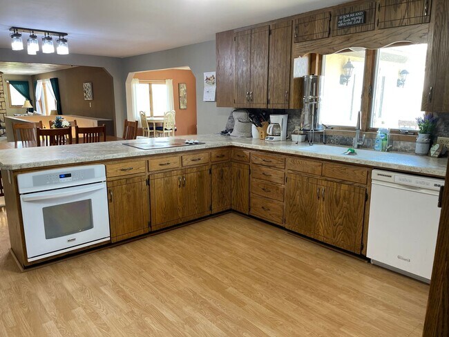 Building Photo - Spacious, four-bedroom, two-bathroom, coun...