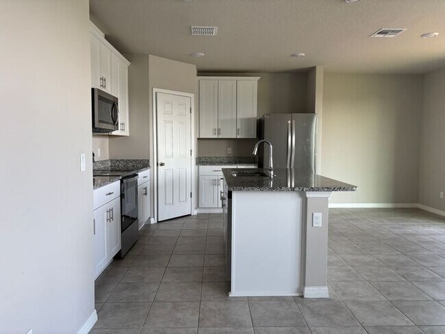 Building Photo - Like-New 4 Bedroom 3 Bath with Pond View & Two Living Spaces — Minutes to South Lake Nona