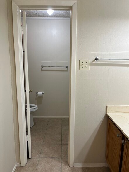 Master Bedroom with dressing/sink area outside toilet/shower area - 400 W South Town Dr