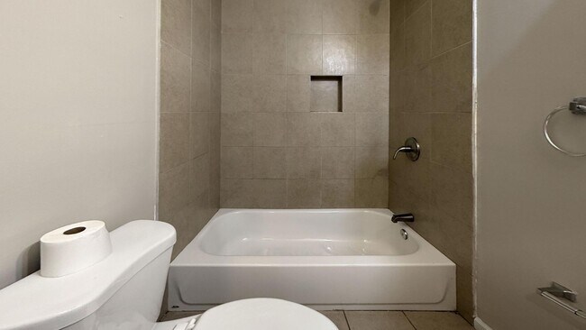 Building Photo - Charming 4BR/2BA Rowhouse with Hardwood-Style Flooring Throughout