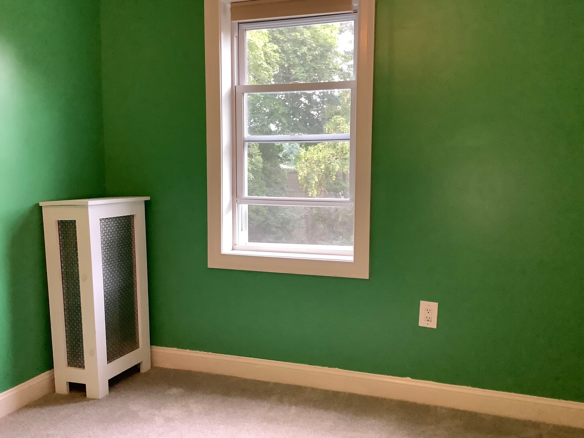 Bedroom 2 overlooks the back yard and measures 13’ by 11’. It has been repainted a neutral color. - 9 Jay St