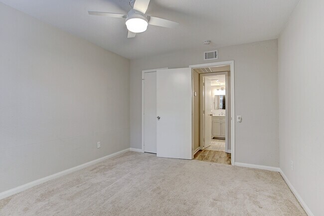 Large bedroom with brand new remote-control fan and walk-in closet - view without furniture. - 1880 White Oak Dr. Apt 119