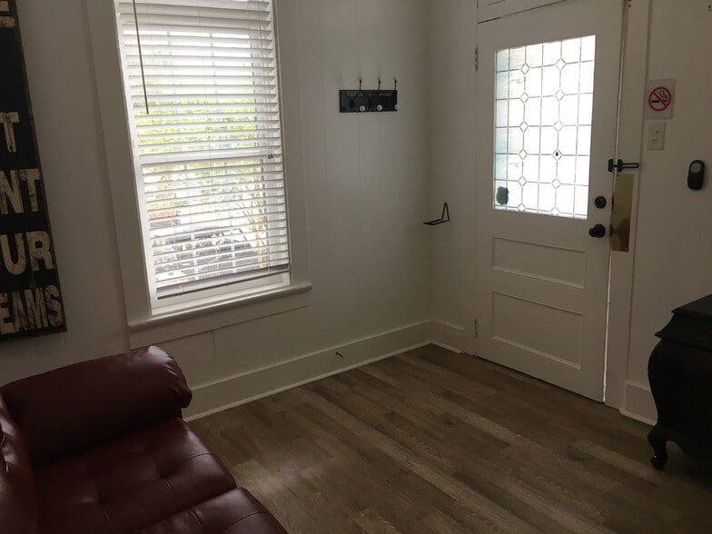 Front door and window that overlooks front courtyard - 7602 Burthe St
