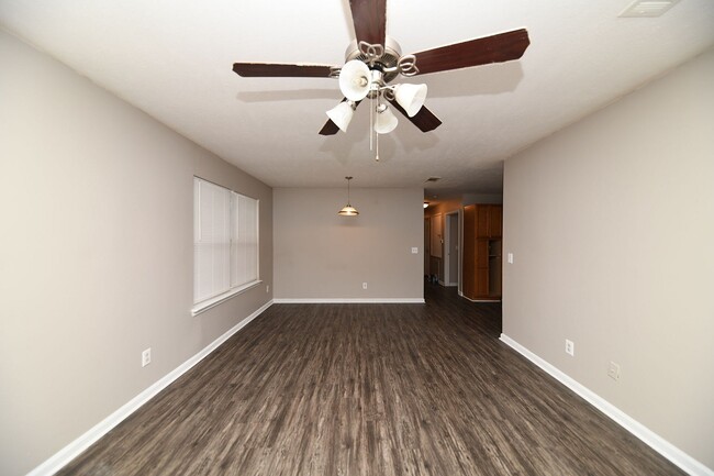 Spacious living room with hardwood-style flooring - Prairie Creek Estates