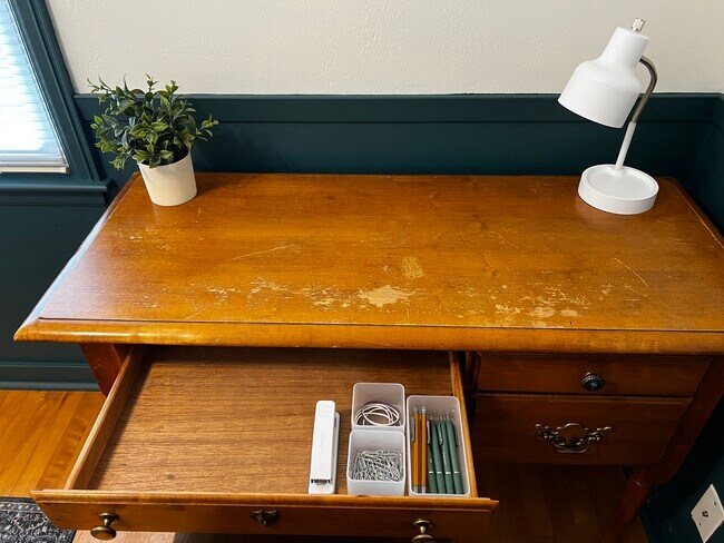 You'll find basic office supplies in the desk, and a wireless printer in the middle bedroom closet. - 228 W Lexington Blvd