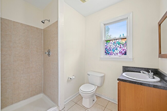 Convenient downstairs bathroom featuring a sleek stand-up shower - 247 Farrington Ave SE