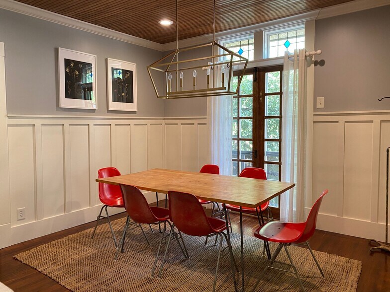 French doors with stained glass accent windows, wall paneling, and beadboard ceiling - 1003 Egan St