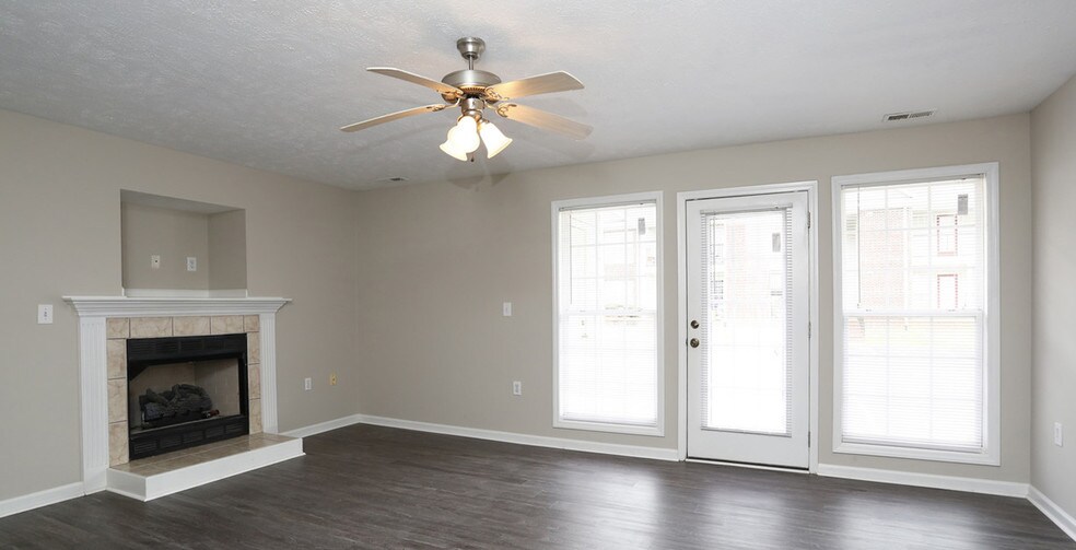 Enjoy plank style flooring and a warm fireplace at your new home - Karen Lake Apartments