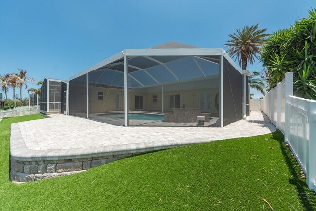 Building Photo - Live the ultimate Space Coast waterfront lifestyle at this stunning beachside canal home in Satel...