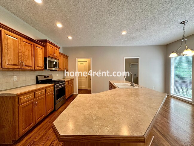 Building Photo - Beautiful Four-Bedroom Home with Three Car Garage, Wood Floors, Finished Basement and a Fenced Ya...