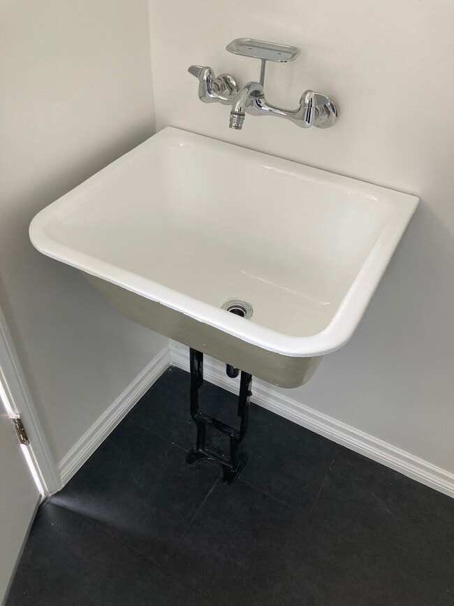original utility sink in washroom - 4715 Allott Ave