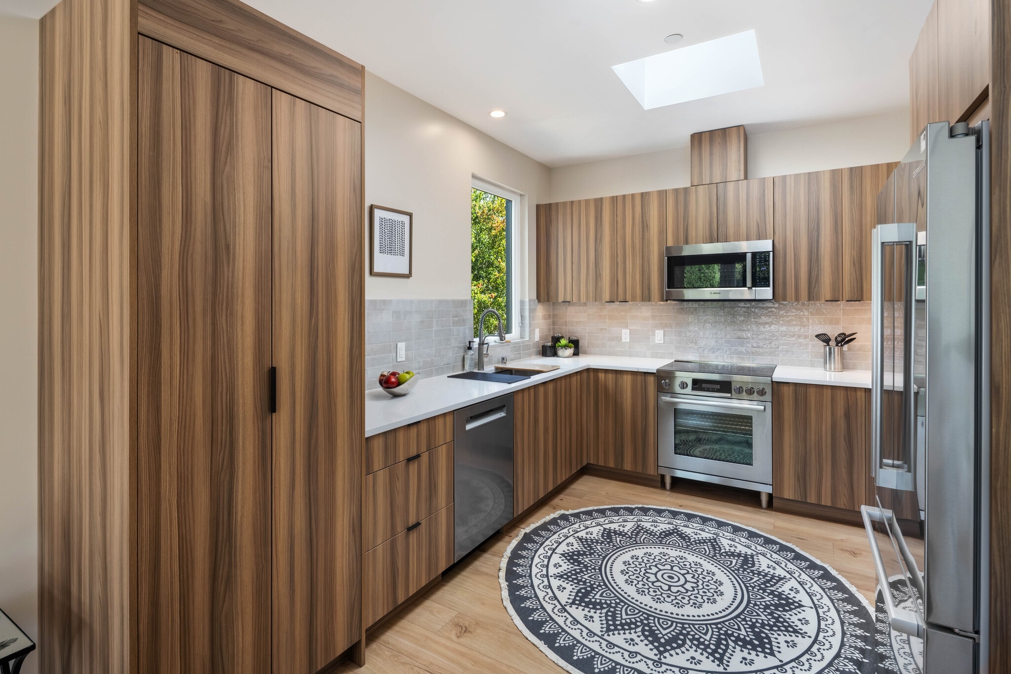 Kitchen with Bosch appliances (dishwasher, induction range, microwave, and refrigerator) - 10120 NE 185th St