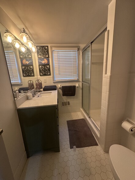 Downstairs shared bathroom — clean, modern, and easily accessible. - 5460 Scofield Rd