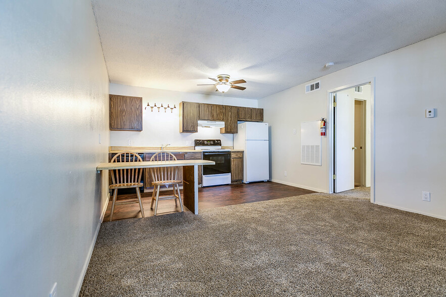 Living Room/Kitchen/Dining Table - Stadium Oaks Apartments