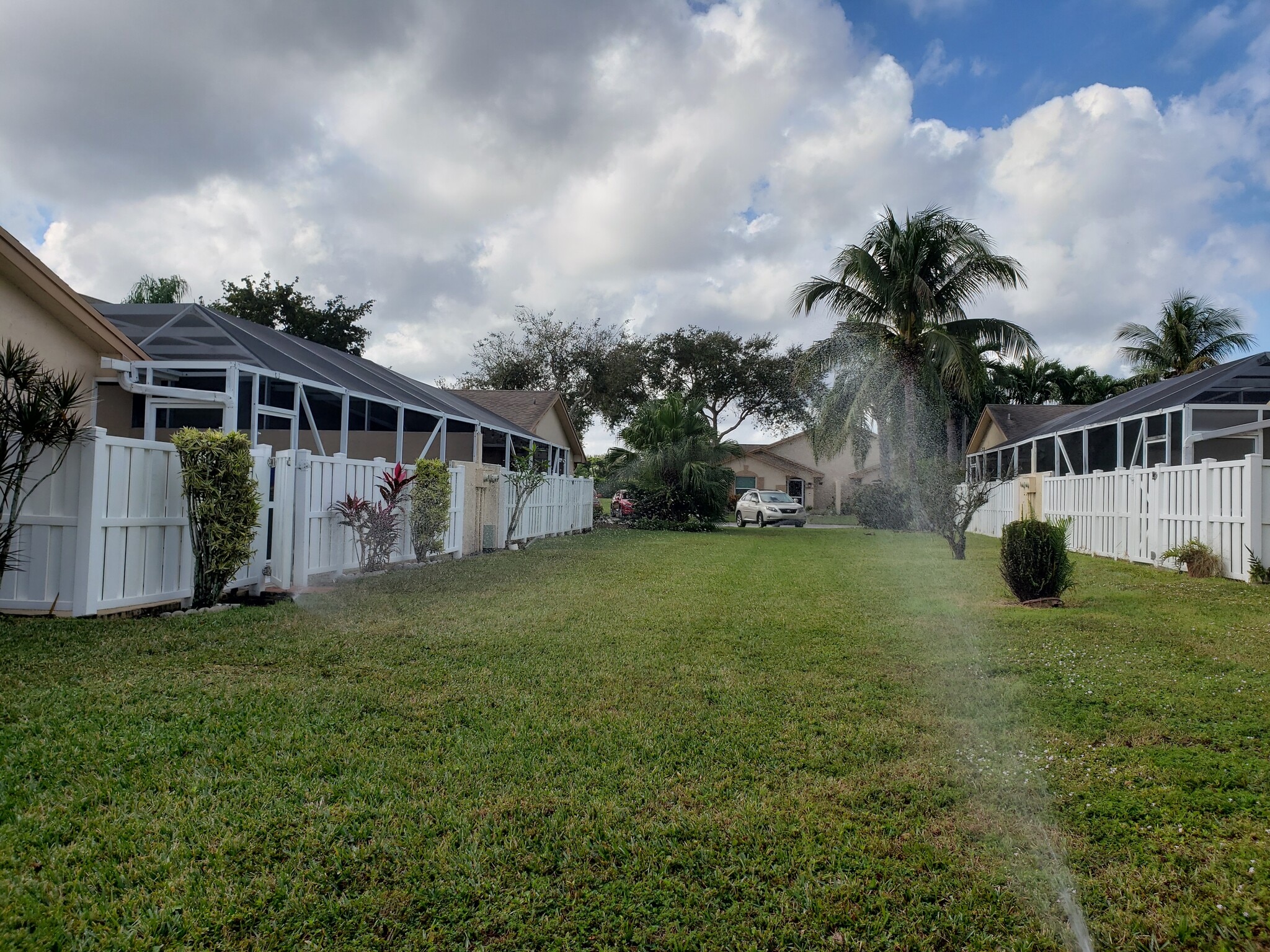 Lots of grass in front and side of villa. Patio fully screened and fenced. - 9441 Boca Gardens Cir S