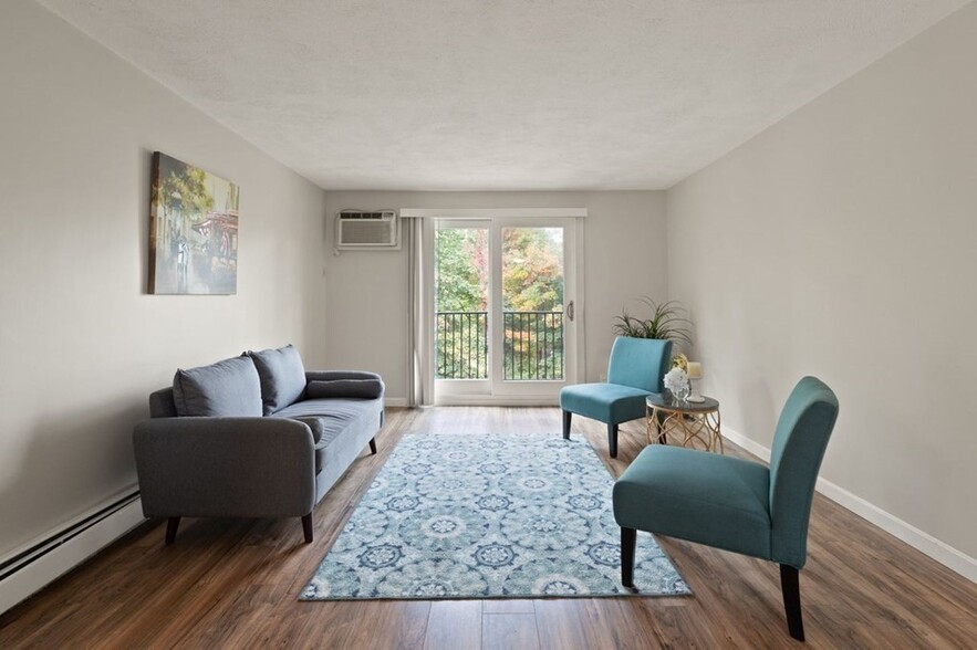 Living room with sliding door to balcony, new flooring, baseboard, and paint - 9 Kenmar Dr