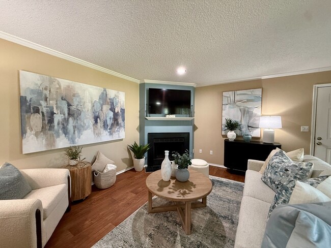 Spacious living room with hardwood-style flooring & fireplace