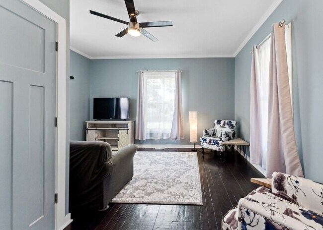 Additional sofa, TV, and chairs in a separate sitting area - 1110 W Grand Ave