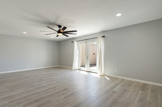 Large living room area and view of private patio french doors - 6030 N 15th St