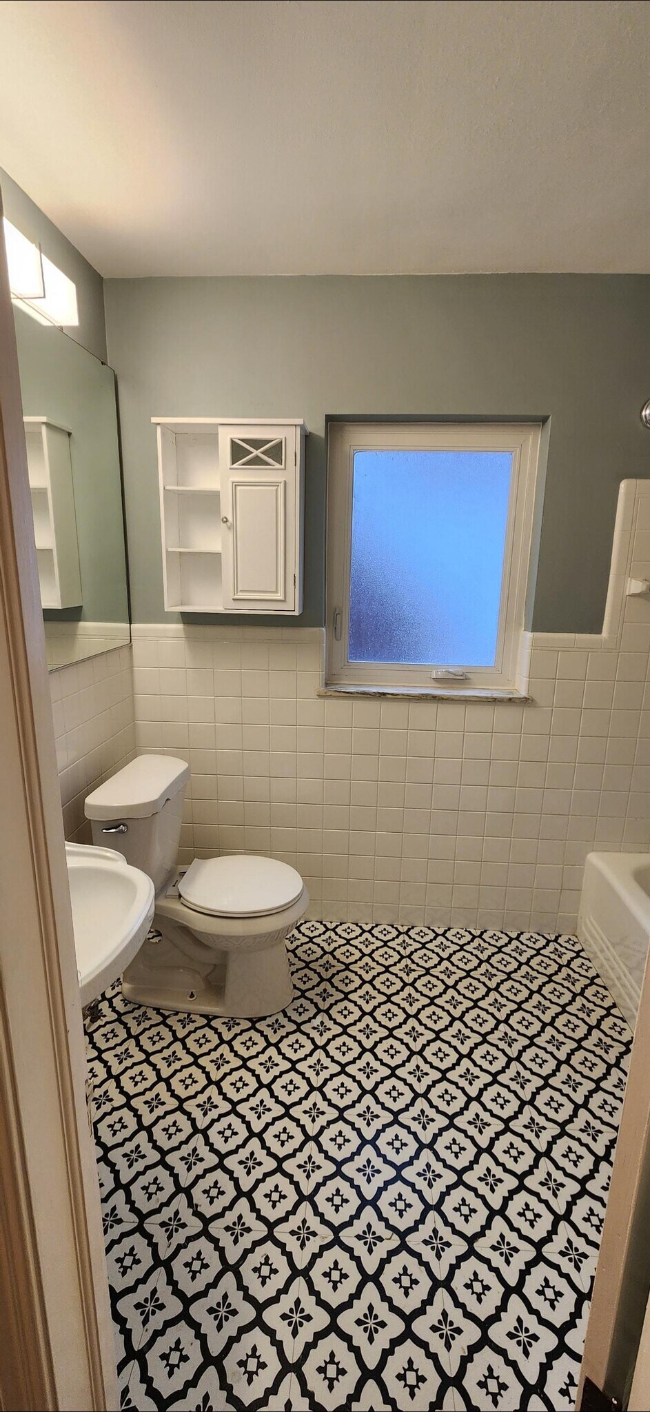 Beautifully remodeled bathroom featuring classic tilework, designer patterned flooring, updated fixt - 90 E 216th St