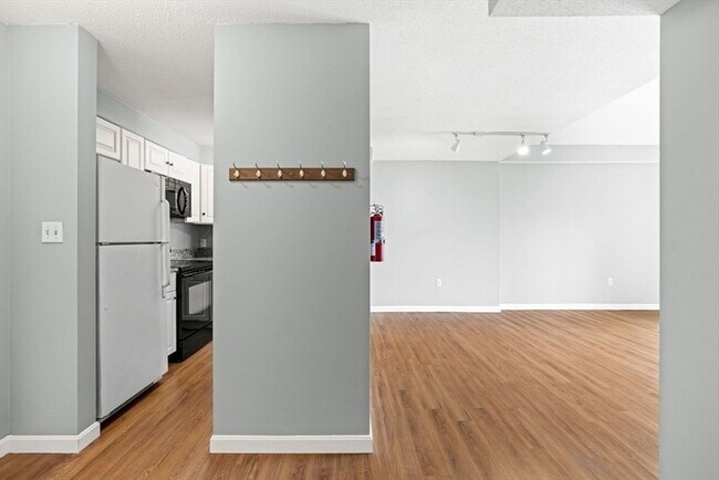 Building Photo - Updated 1BR Condo with Balcony, Garage Parking & Storage Near Commuter Rail