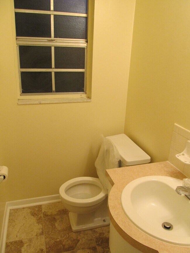 Building Photo - Three bedroom one and a half bathroom house with large yard space