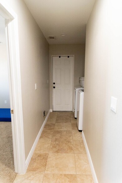 Hall to bedroom, laundry room, and garage - 12072 Pacific Rd