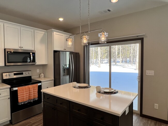 Center island kitchen, quartz top, patio door to covered patio - 300 Thumper Lodge Rd