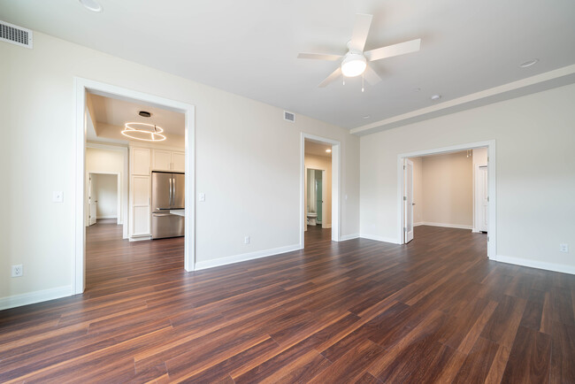 201 living room looking into secondary bedroom - Peregrine Square