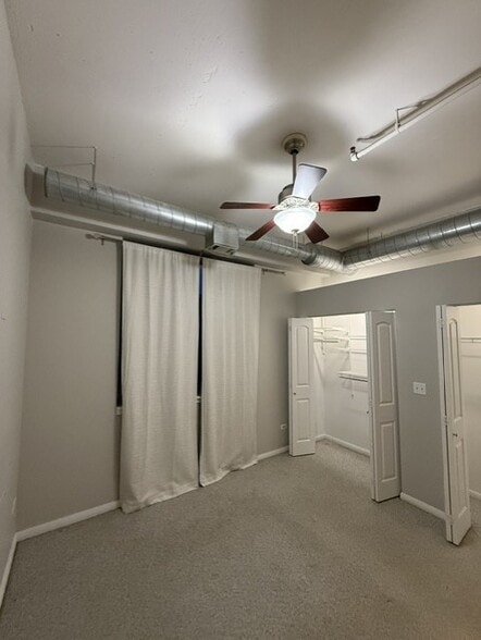 bedroom curtains and view of double closets - 950 W Monroe St