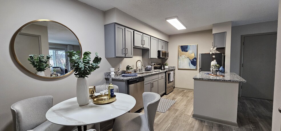 Kitchen with granite counters and modern cabinetry - Kinley Flats