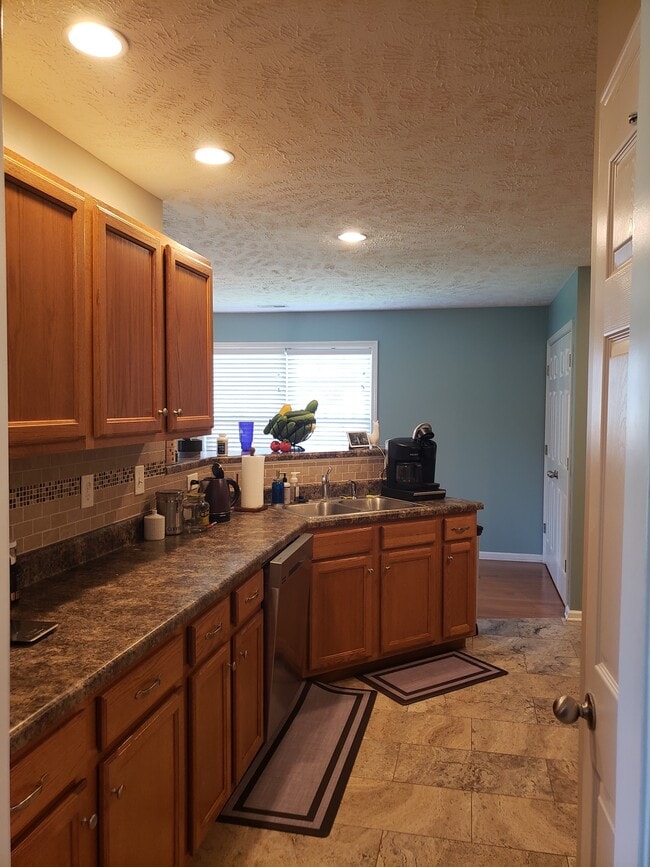 Large kitchen with stainless steel double sink lots of cabinets and great layout for cooking. - 820 Laramie Ct