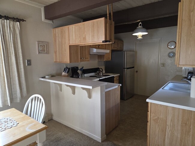 Building Photo - Unique open design,wood beams in all rooms-Very cheery and cozy. Newly remodeled, and newly furni...