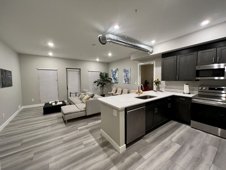 Large Living Room, Kitchen with expansive self-closing cabinets, quartz and appliances - 10020 E Girard Ave