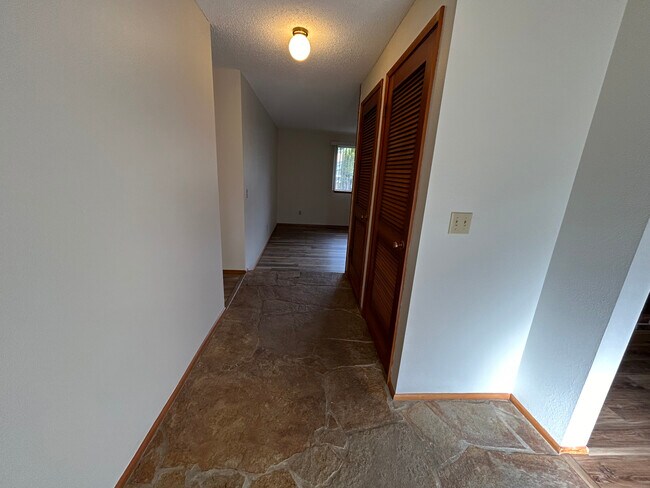 Entry foyer with slate tile a coat closet and furnace in other closet. - 8519 49th St W