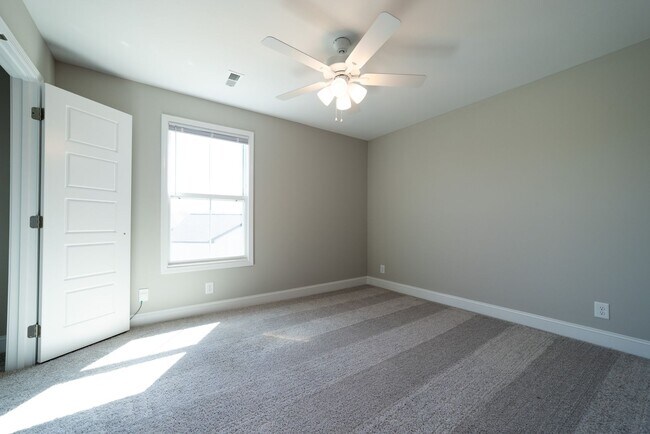 Building Photo - Elegant Home with Stone Fireplace, Kitchen Island and Designer Primary Suite