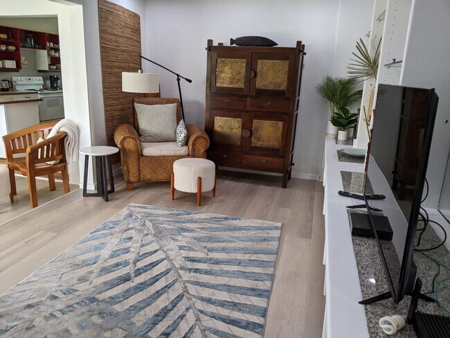 Open sitting room with teak and koa furniture - 426 Ilimano St
