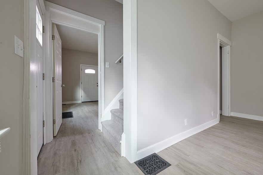 Staircase to second and third bedroom divides first floor bedroom from spacious living room - 2354 Victor St
