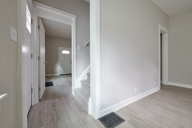 Staircase to second and third bedroom divides first floor bedroom from spacious living room - 2354 Victor St