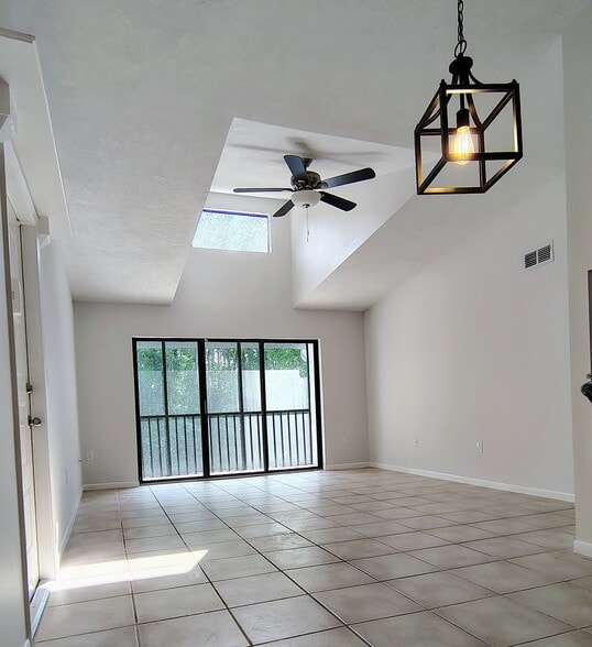 Open dining room/living room with lots of light! - 1353 Pine Ridge Cir E