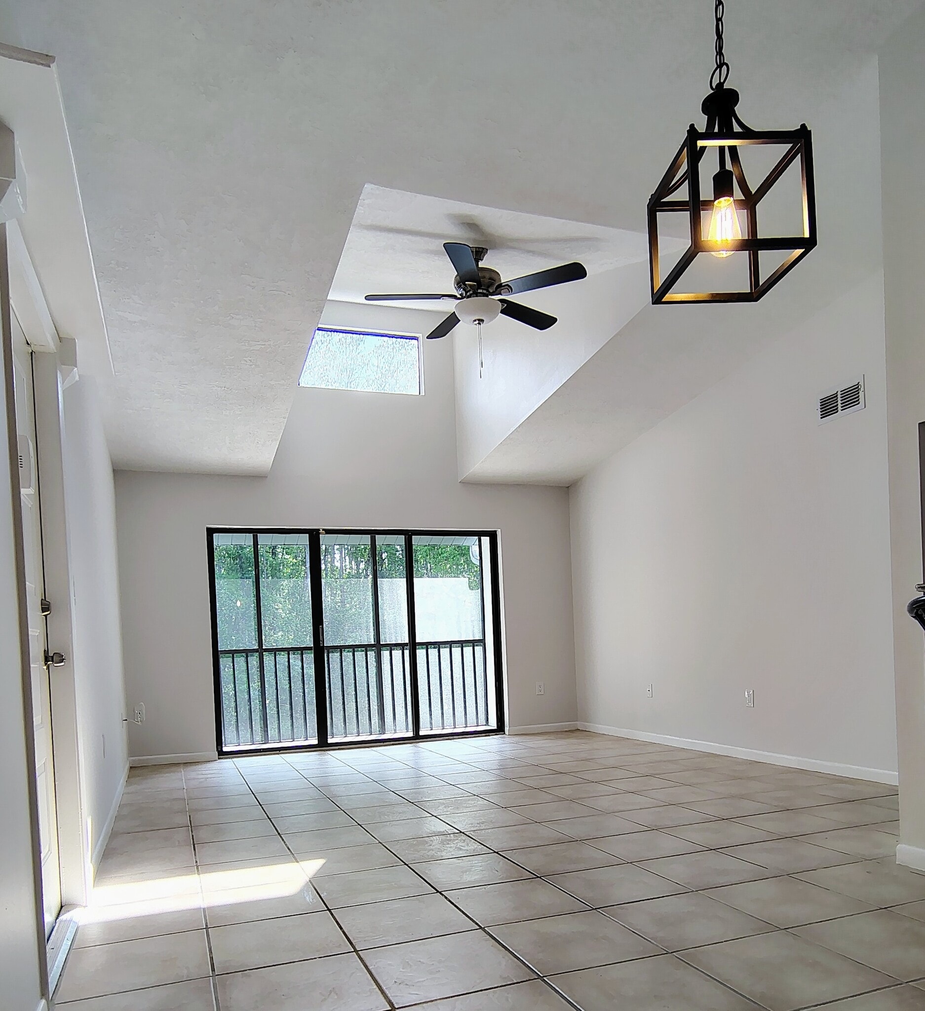 Open dining room/living room with lots of light! - 1353 Pine Ridge Cir E