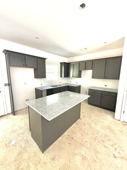 Large kitchen with granite countertops and island. Plenty of cabinet space. - Stephens Court