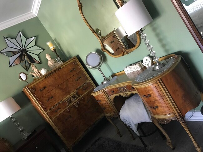 Vanity set in master bedroom opposite large dresser and walk-in closet. - 3822 Berryman Ave