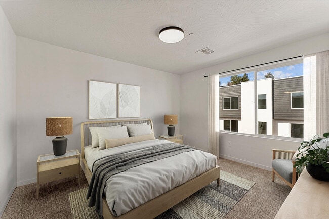 Bright, modern bedroom with elegant neutral tones, large window, and stylish decor for a serene retreat. - Coal Creek Townhomes