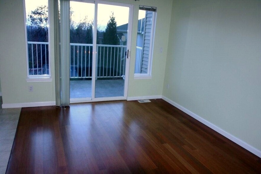 Living room with small balcony overlooking city skyline - 2680 139th Ave SE