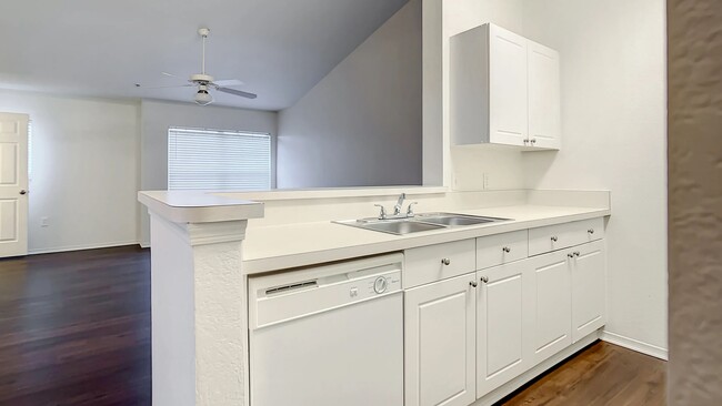 Step into timeless kitchen elegance where our kitchens feature generous countertop space and a versatile breakfast bar that looks out onto the living room. - Charleston Cay