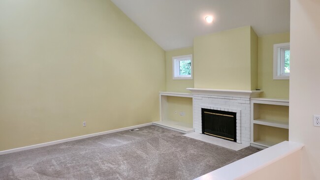 Family room off kitchen with vaulted ceilings and fireplac - 7409 245th Way NE