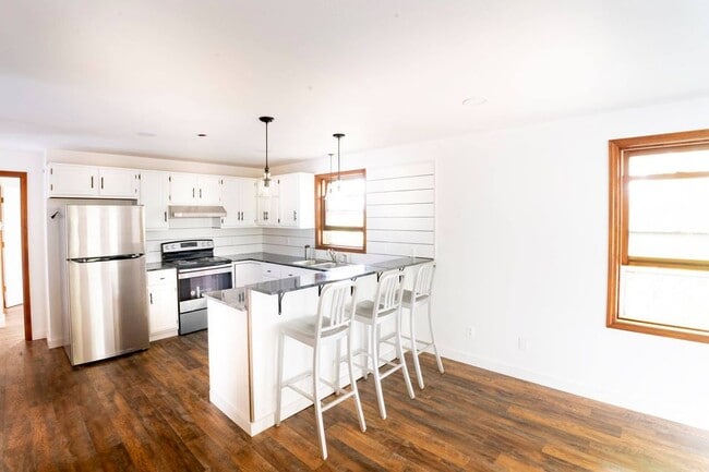 Renovated kitchen with stainless steel appliances and granite countertops - 8 Virginia St