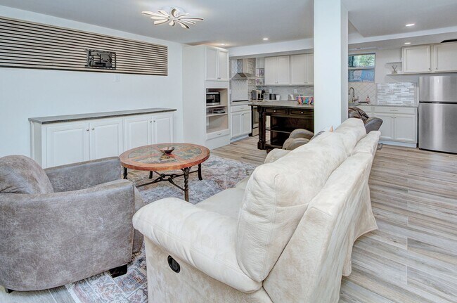 Building Photo - Discover the charm of this FULLY FURNISHED basement unit, tucked away in a beautifully updated bu...